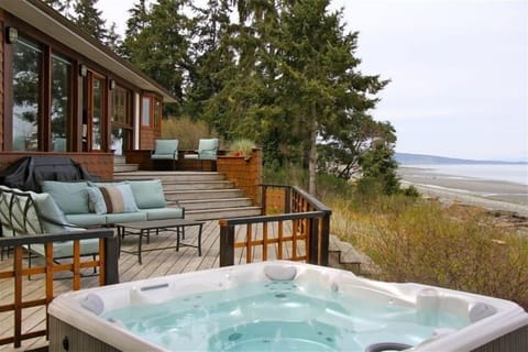 Relax in the hot tub to the sound of waves on the beach a few feet away.