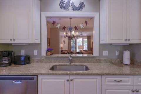 View from kitchen through DR, LR to lake