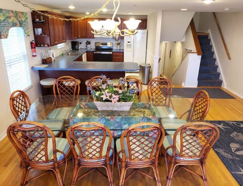 Main dining table with seating for 10 and spacious kitchen with 5 counter stools