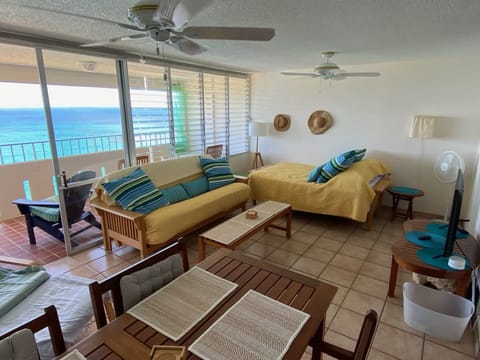 Common area with bed, futon couch, and television