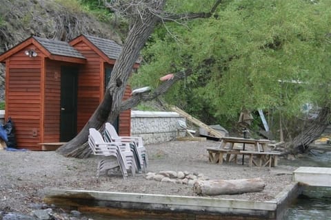 Waterfront shed with fridge, picnic table and fire pit.