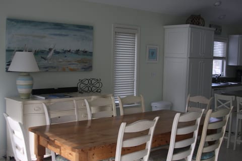 Dining Area with new decor.  Table easily seats 8.  More seating on deck outside