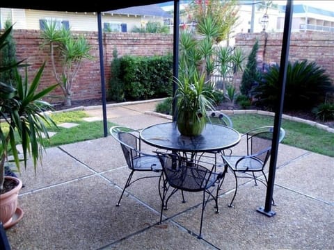 Private courtyard offers outdoor dining option with view of Beau Rivage Resort. 