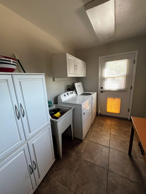 Laundry room with full-sized washer and dryer.