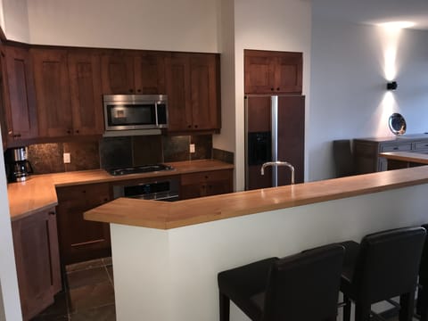 Custom kitchen with Jenn Air appliances: full oven, 4 burner cooktop, fridge-DW.