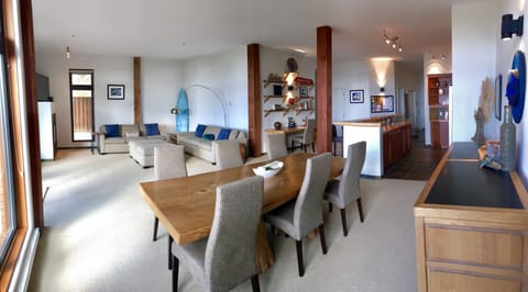 Open concept living space with floor to ceiling windows.