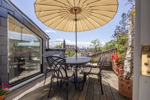 Terrace with table and 6 chairs and parasol