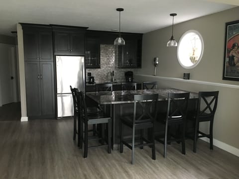 Stunning lower level bar/kitchen area. Great place to play games or have drinks.