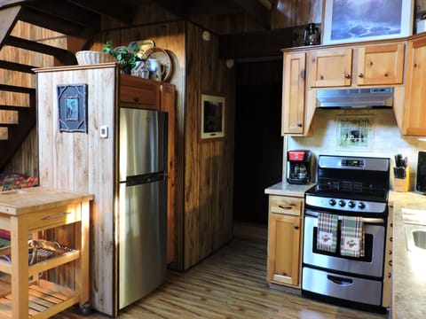 Kitchen with a movable island and cutting top.