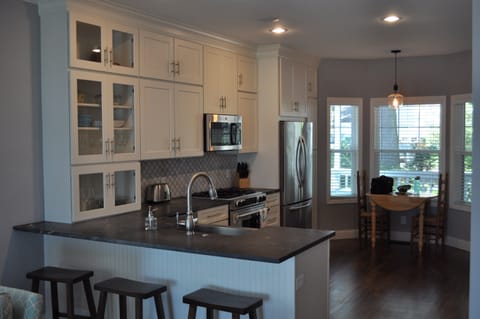 Open kitchen overlooking the porch and river.  Seating for 7 inside.