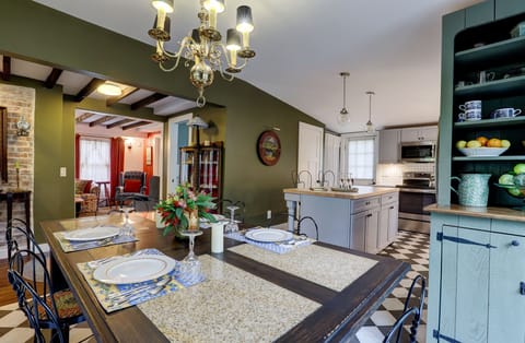 Dining Area with Table and Vintage Chairs and Hutch with Living Room in Distance