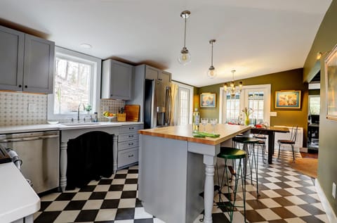 Open Plan Kitchen / Dining Area with French Doors and Screen Porch in Distance