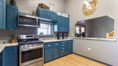 The handy pass-through serving bar in the kitchen is a convenient feature that enhances the dining experience. It provides a seamless way to serve or display drinks and food without navigating the kitchen.