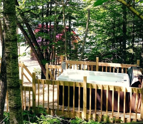 Large hot tub with views of the lake and woods