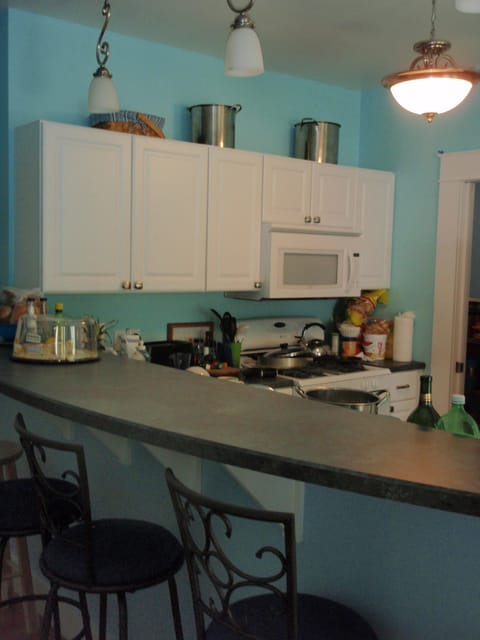 Kitchen with counter bar, dishwasher and microwave