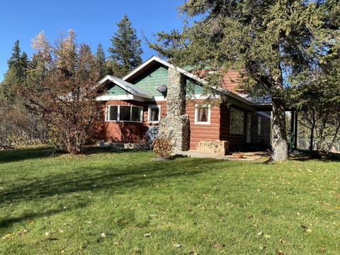 Southern view of home with vintage bay window and chimney.