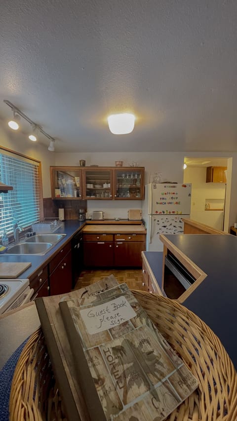 View of kicthen from dining room with guest books featured.