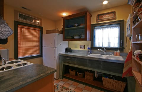 standing at stair, living room behind me, looking into kitchen