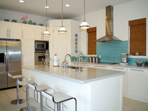 Kitchen is stocked full of stainless steel appliances and has plenty of kitchen