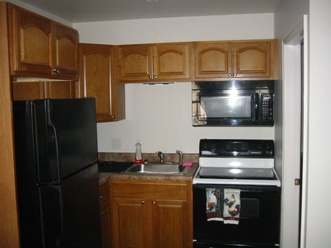 Kitchen with Pots and Pans, dishes etc. Coffee Pot. Toaster. Microwave.