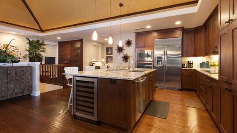 Gourmet kitchen equipped with high-end appliances, built in wine fridge, essential, cookware and a nice assortment of spices and oils.