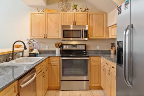 The fully equipped kitchen has everything you need to prepare meals at home including stainless steel appliances and a kitchen bar with 3 bar stools.