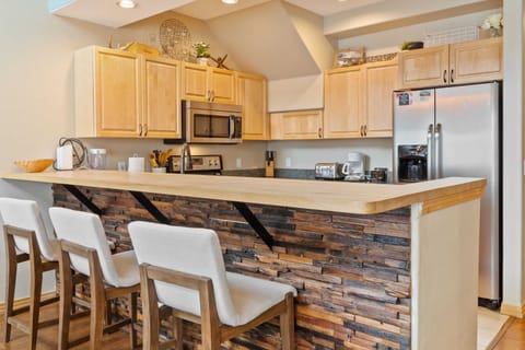 The fully equipped kitchen has everything you need to prepare meals at home including stainless steel appliances and a kitchen bar with 3 bar stools.