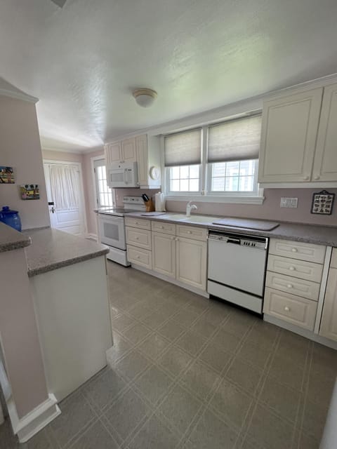 Sunny kitchen with ample countertop space and kitchenware