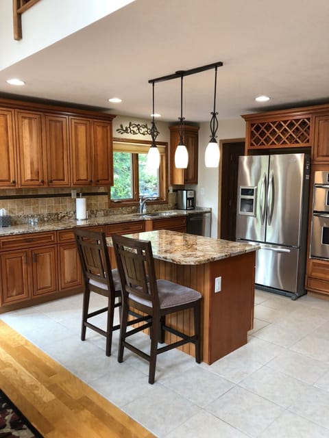 Beautiful granite counters, cabinetry, & tile flooring.  Very stocked kitchen.