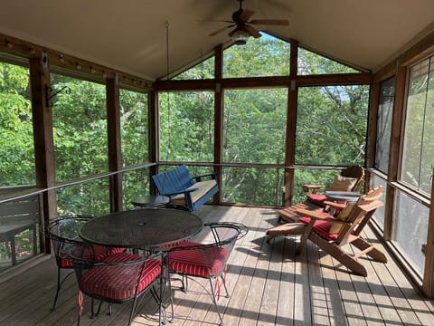 Large screened-in porch with ceiling fans and outdoor speakers