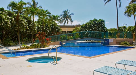 The Olympic-size pool is surrounded by shade from blooming Plumeria trees