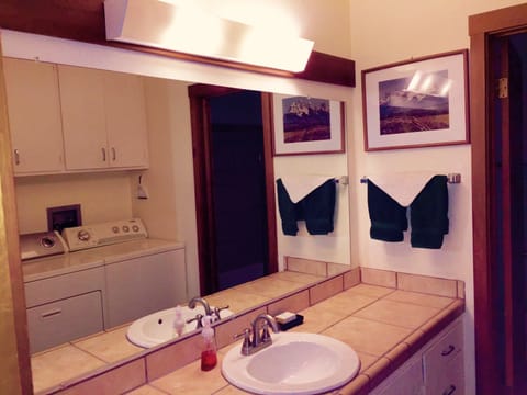 Vanity area of bathroom,  adjacent laundry, now larger Maytag commercial grade.
