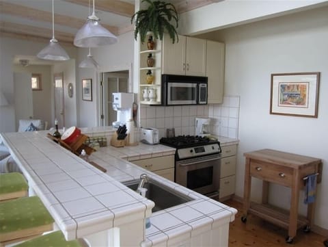 Kitchen with oven, range, microwave, wrap-around bar overlooking the ocean