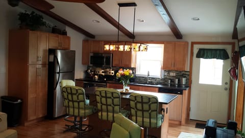 Kitchen with granite counter tops & stainless appliances.