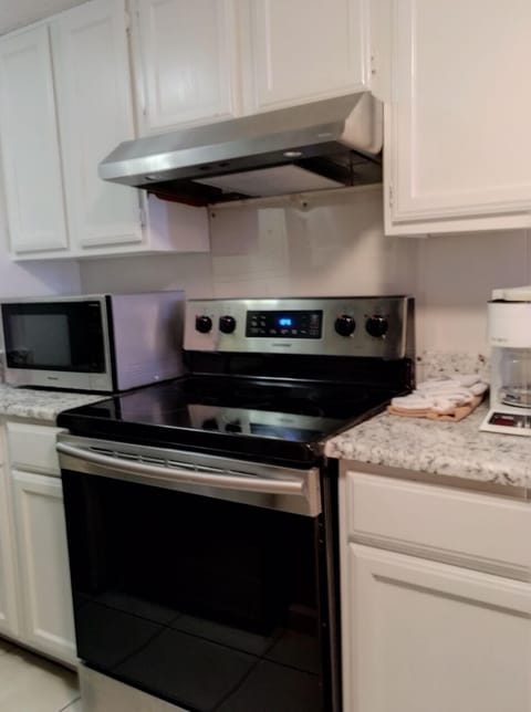 Stainless steel appliances, granite and freshly painted cabinets