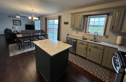 Another view of the open floorplan - kitchen, dining , living with lake views.