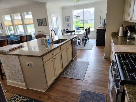 Looking into the kitchen from back hallway, pantry , laundry area