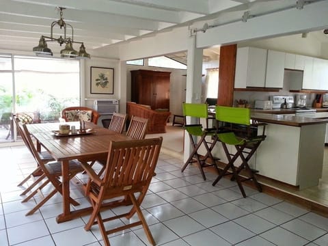 Dining area. Teak table. Tall bar stools at island bar.