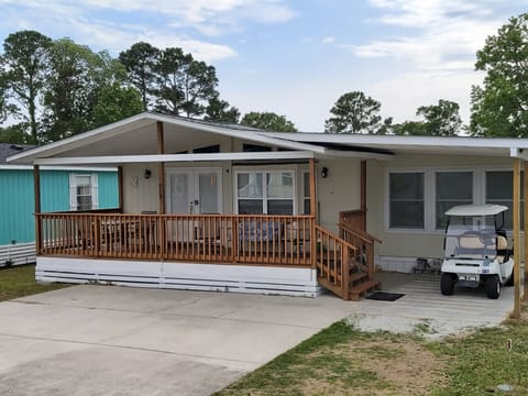 House with large deck and covered golf cart parking. Up to 3 cars can park. 