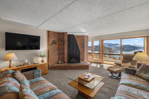 Family room TV, fireplace, queen size sofas and deck sliding glass door 