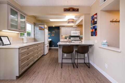 Kitchen area open to dining room features bar seating for 2
