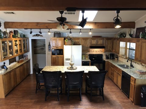 A kitchen with anything needed to prepare, serve and eat.