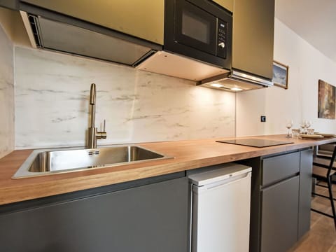 Countertop, Kitchen, Furniture, Interior Design, Kitchen Appliance, Cabinetry, Flooring, Wood, Major Appliance, Floor