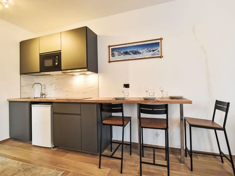 Furniture, Interior Design, Flooring, Wood, Countertop, Floor, Kitchen, Cabinetry, Lighting, Room