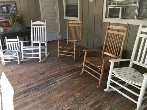 Front porch full of rocking chairs.