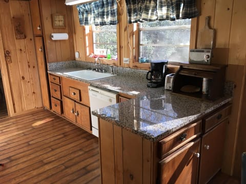 Kitchen with dishwasher and granite countertops