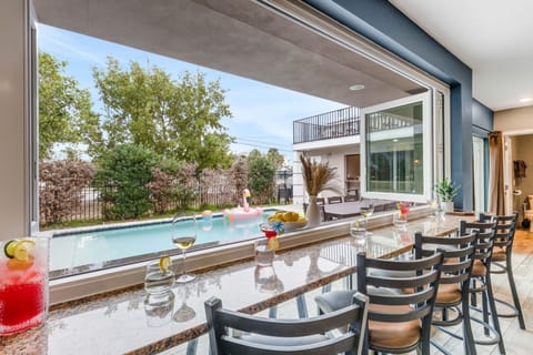 Located just a block from the white sands of Clearwater Beach, this home features a private heated pool, an incredible outdoor entertainment bar