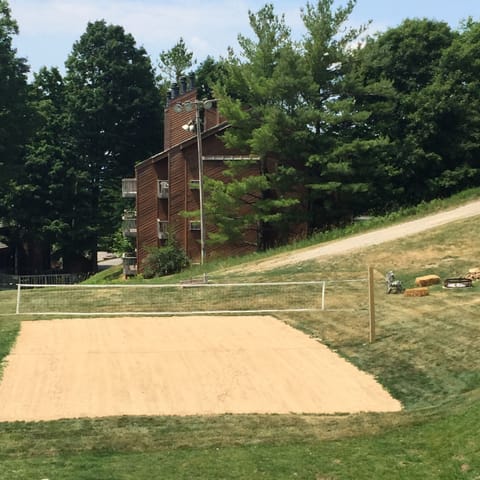 Sand volleyball behind Summit Hotel.
