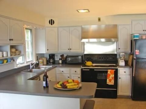 Modern, light filled eat-in kitchen with double oven, griddle and water views