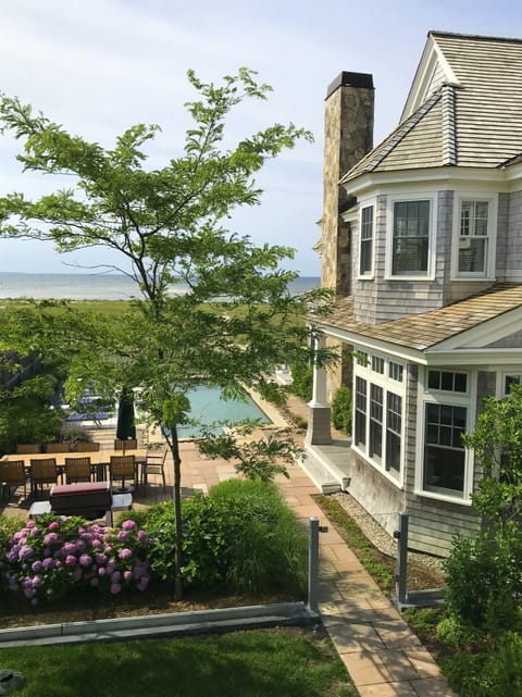 View to pool, main house, and Bay from Carriage house deck.